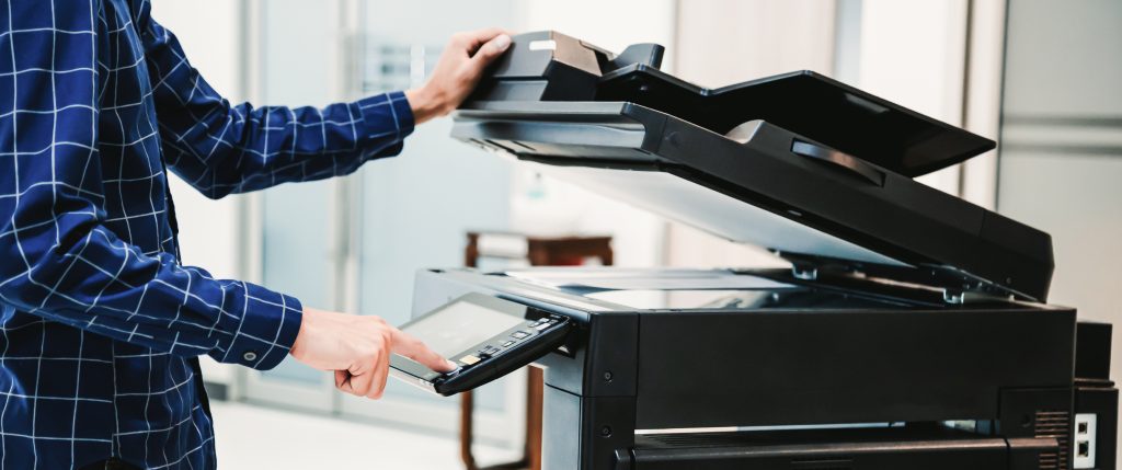 Inkjet technology - Copier printer, Close up hand office man press copy button on panel to using the copier or photocopier machine for scanning document printing a sheet paper.