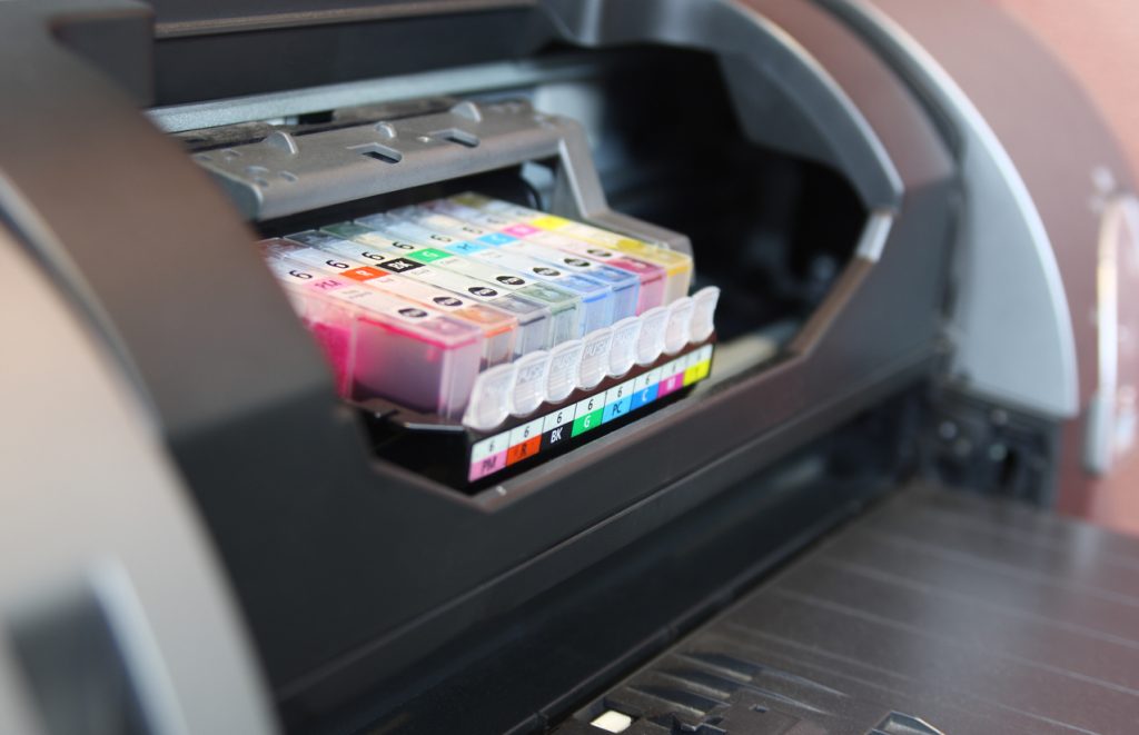 Close up on inkjet printer CMYK cartridge. Shallow DOF
